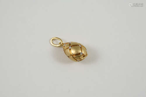 A DIAMOND AND 18CT. GOLD EGG PENDANT BY TIFFANY & CO. the engraved egg is mounted with circular-