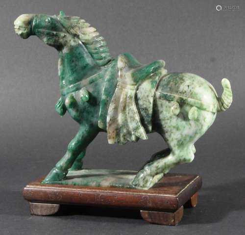 CHINESE MOTTLED GREEN NEPHRITE JADE HORSE, Tang style, modelled leaning back, on a hardwood stand,