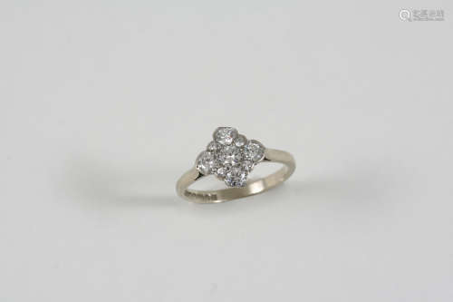 A DIAMOND CLUSTER RING millegrain set with graduated circular-cut diamonds, in 18ct. white gold.