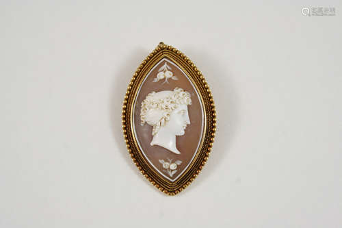 A CARVED SHELL CAMEO BROOCH of navette shape, depiciting the profile of a classical woman, in