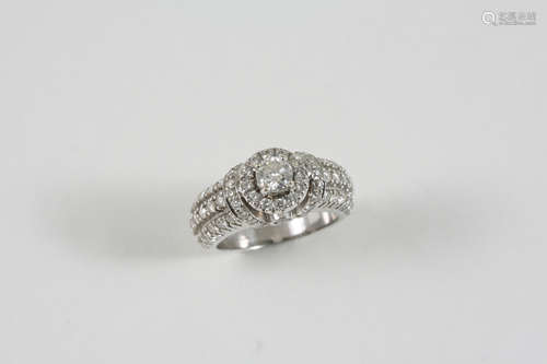 A DIAMOND CLUSTER RING centred with a circular-cut diamond weighing approximately 0.30 carats and