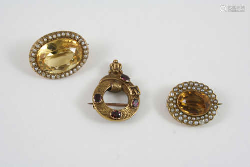 A CITRINE AND PEARL SET BROOCH the oval-shaped citrine is set within a surround of small pearls,