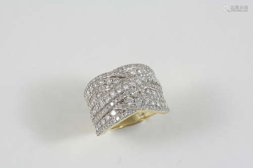 A DIAMOND RING formed with nine overlapping rows of graduated circular-cut diamonds, in 9ct. gold.