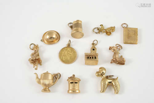 ELEVEN ASSORTED 9CT. GOLD CHARMS 23 grams, together with a 14ct. gold charm and two other charms.