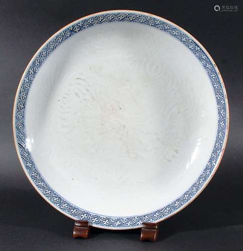 CHINESE SAUCER DISH, probably Qianlong, carved with chrysanthemum flowers inside a blue painted