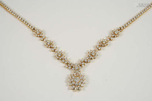 A DIAMOND NECKLACE the foliate and flowerhead design is set overall with graduated brilliant-cut,