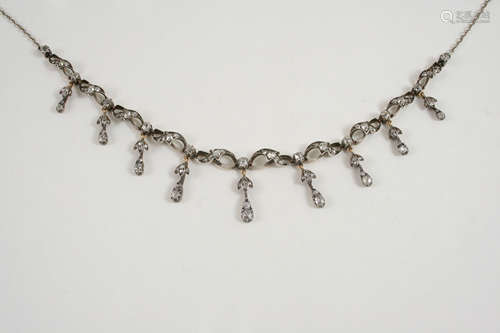 A VICTORIAN DIAMOND NECKLACE the scrolling design is set with graduated old brilliant-cut diamonds