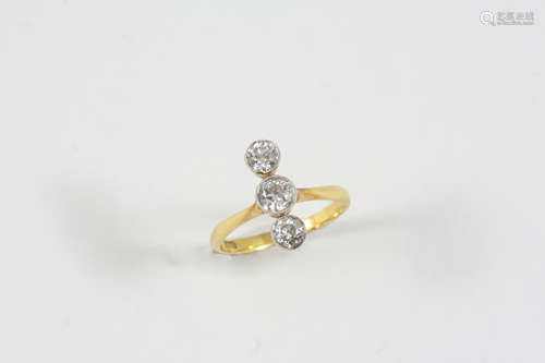 A DIAMOND THREE STONE RING the three circular-cut diamonds are collet set in 18ct. gold. Size O.