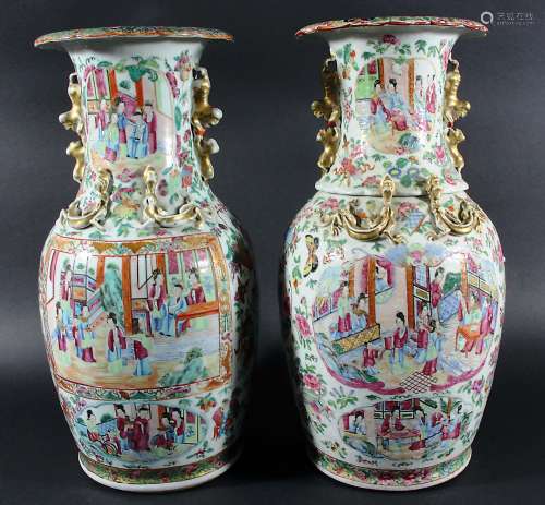 NEAR PAIR OF CHINESE FAMILLE ROSE VASES, 19th century, painted in the Canton style with panels of