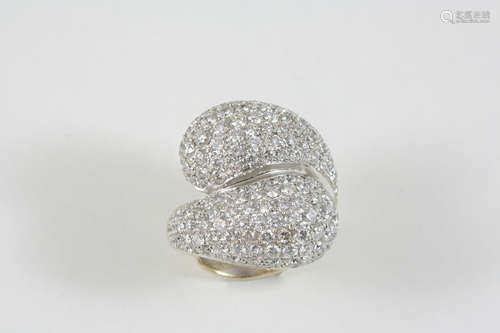 A DIAMOND COCKTAIL RING the over-lapping design is set overall with graduated brilliant-cut