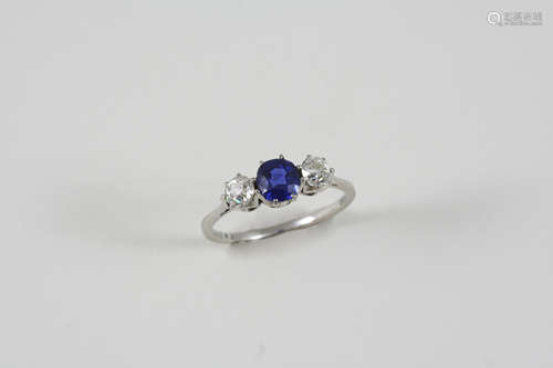 A SAPPHIRE AND DIAMOND THREE STONE RING the circular-cut sapphire is set with two circular-cut