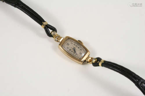 A LADY'S GOLD WRISTWATCH BY ROLEX the tonneau shaped dial with Arabic numerals, numbered to the back