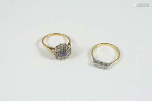 A SAPPHIRE AND DIAMOND CLUSTER RING the circular-cut sapphire is set within a surround of old