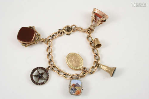 A 15CT. GOLD CHAIN LINK BRACELET suspending a spinning gold fob set with a bloodstone and carnelian,