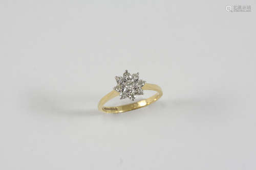 A DIAMOND CLUSTER RING set with circular-cut diamonds, in 18ct. gold. Size M.