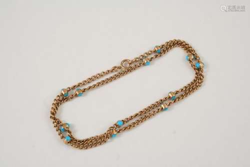 A GOLD AND TURQUOISE NECKLACE the 9ct. gold chain is mounted with circular turquoise cabochons,