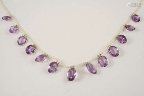 AN AMETHYST AND SEED PEARL NECKLACE the seed pearl necklace is mounted with thirteen graduated