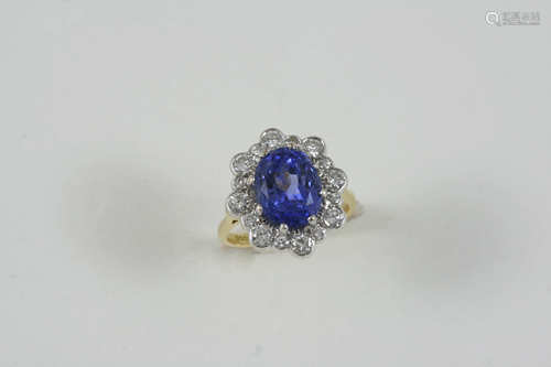 A SAPPHIRE AND DIAMOND CLUSTER RING the oval-shaped sapphire weighs 5.57 carats and is set within