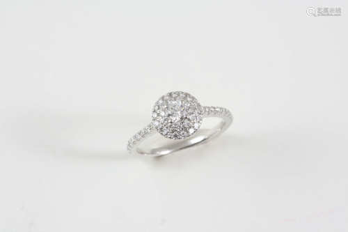 A DIAMOND CLUSTER RING set with a brilliant-cut diamond within a double surround of small