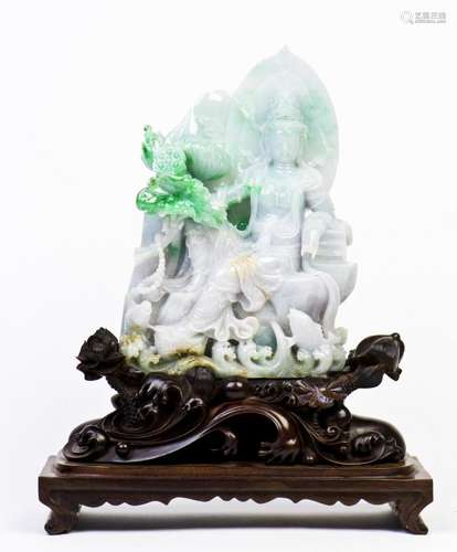 A 'SEATED GUAN YIN' JADEITE WITH STAND