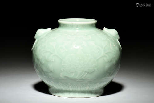 A CARVED CELADON-GLAZED JAR