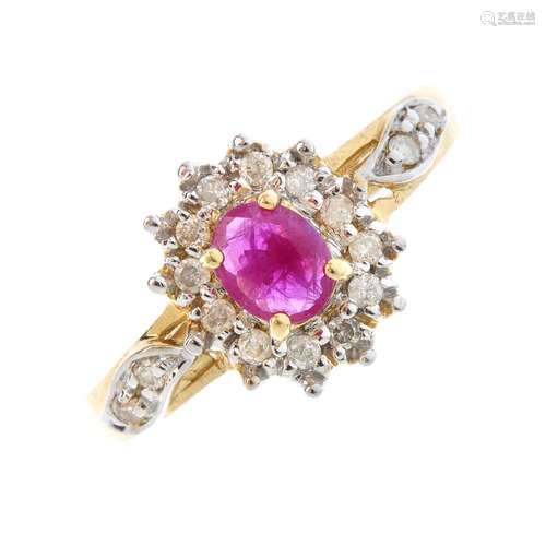 A 9ct gold ruby and diamond cluster ring. The oval-shape ruby, with brilliant-cut diamond surround