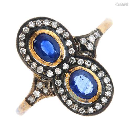 A sapphire and diamond dress ring. Designed as two oval-shape sapphire collet, each within a