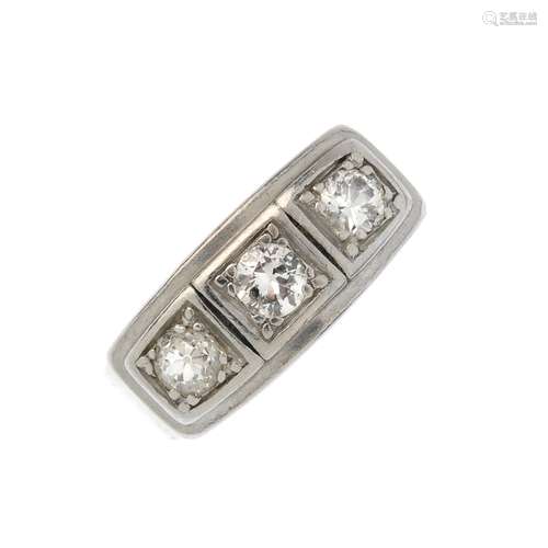 A diamond three-stone ring. The brilliant-cut diamond line, within a raised rectangular panel and