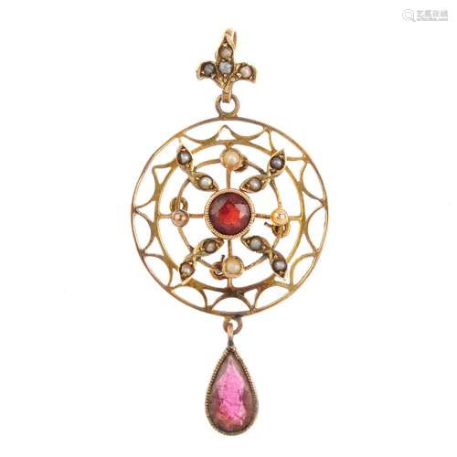 An early 20th century garnet and split pearl pendant. The pear-shape garnet, suspended from a