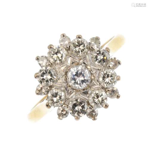 An 18ct gold diamond and gem-set cluster ring. The central circular-shape colourless gem, within a