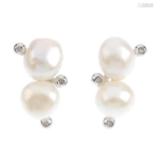 A pair of cultured pearl earrings. Each designed as a cultured pearl line, with brilliant-cut