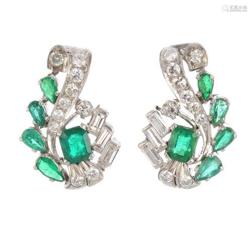 A pair of diamond and emerald earrings. Each designed as a rectangular-shape emerald, with vari-