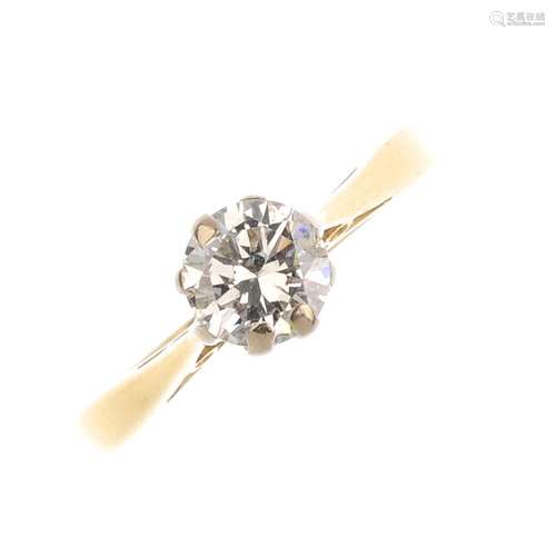 An 18ct gold diamond single-stone ring. The brilliant-cut diamond, with slightly tapered shoulders