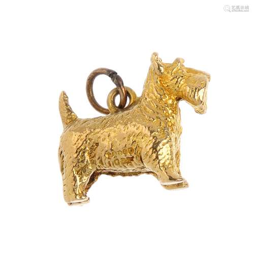 A 9ct gold dog charm. Designed as a textured Scottish Terrier, with hoop surmount. Hallmarks for