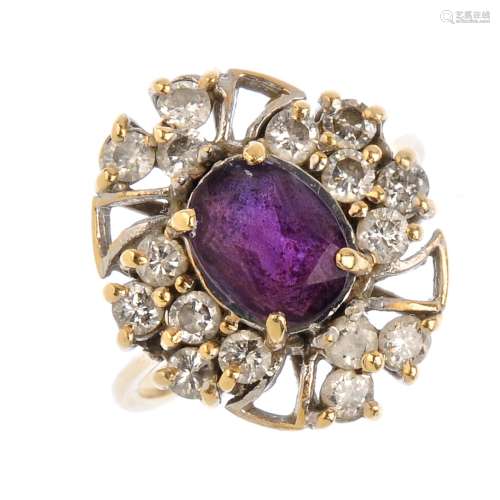 An amethyst and diamond cluster ring. The oval-shape amethyst, with brilliant-cut diamond openwork