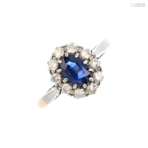 A sapphire and diamond cluster ring. The oval-shape sapphire, with brilliant-cut diamond surround.