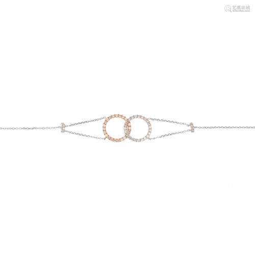 A diamond bracelet. Of bi-colour design, the brilliant-cut diamond interlinked hoops, with trace-