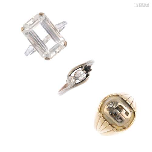 Three items of gem-set jewellery. To include a colourless gem accent signet ring, a topaz single-