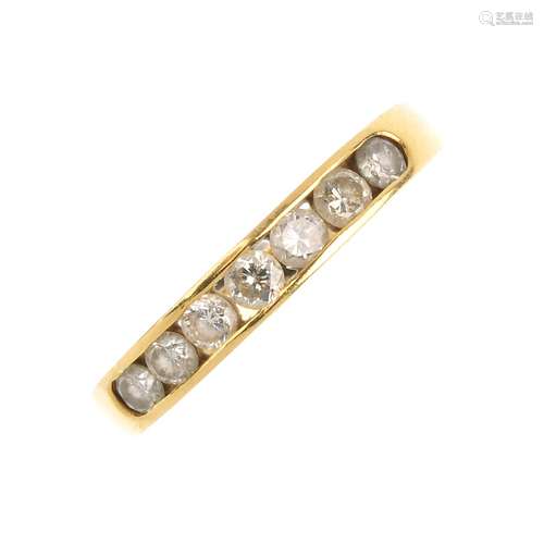 An 18ct gold diamond half eternity ring. The brilliant-cut diamond line, within a channel setting,