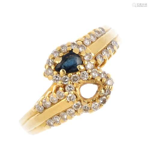 An 18ct gold sapphire and diamond crossover ring. The pear-shape sapphire, with brilliant-cut