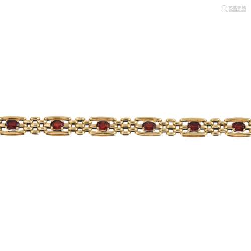 A 9ct gold garnet bracelet. Designed as a series of oval-shape garnets, each with bar sides and