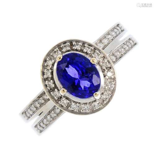 A tanzanite and diamond cluster ring. The oval-shape tanzanite, with brilliant-cut diamond