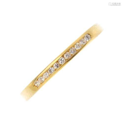 An 18ct gold diamond half eternity ring. The brilliant-cut diamond line, inset to the tapered