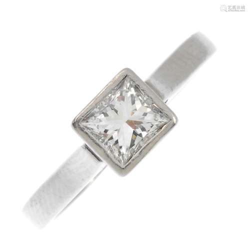 A platinum diamond single-stone ring. The square-shape diamond, within a collet mount, to the