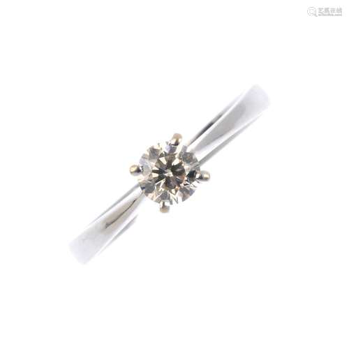 A diamond single-stone ring. The brilliant-cut diamond, with tapered shoulders and plain band.