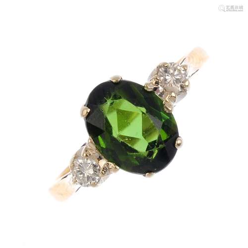 An 18ct gold tourmaline and diamond dress ring. The oval-shape green tourmaline, with brilliant-