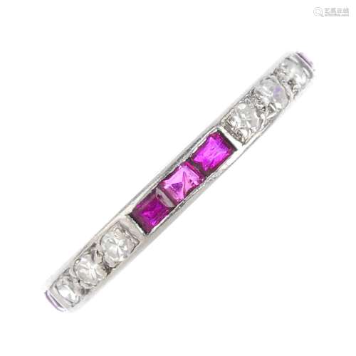 A diamond and ruby full eternity ring. Designed as alternating lines of single-cut diamond and