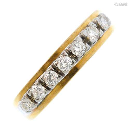 A 1970's 18ct gold diamond seven-stone ring. The brilliant-cut diamond line, atop a plain band.