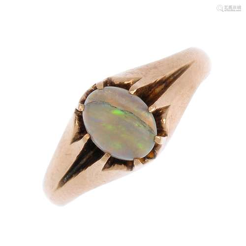 An opal single-stone ring. The oval opal cabochon, with grooved shoulders to the plain band. Ring