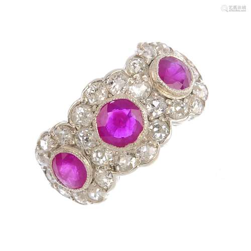 A ruby and diamond dress ring. Designed as three circular-shape rubies, each within a rose-cut